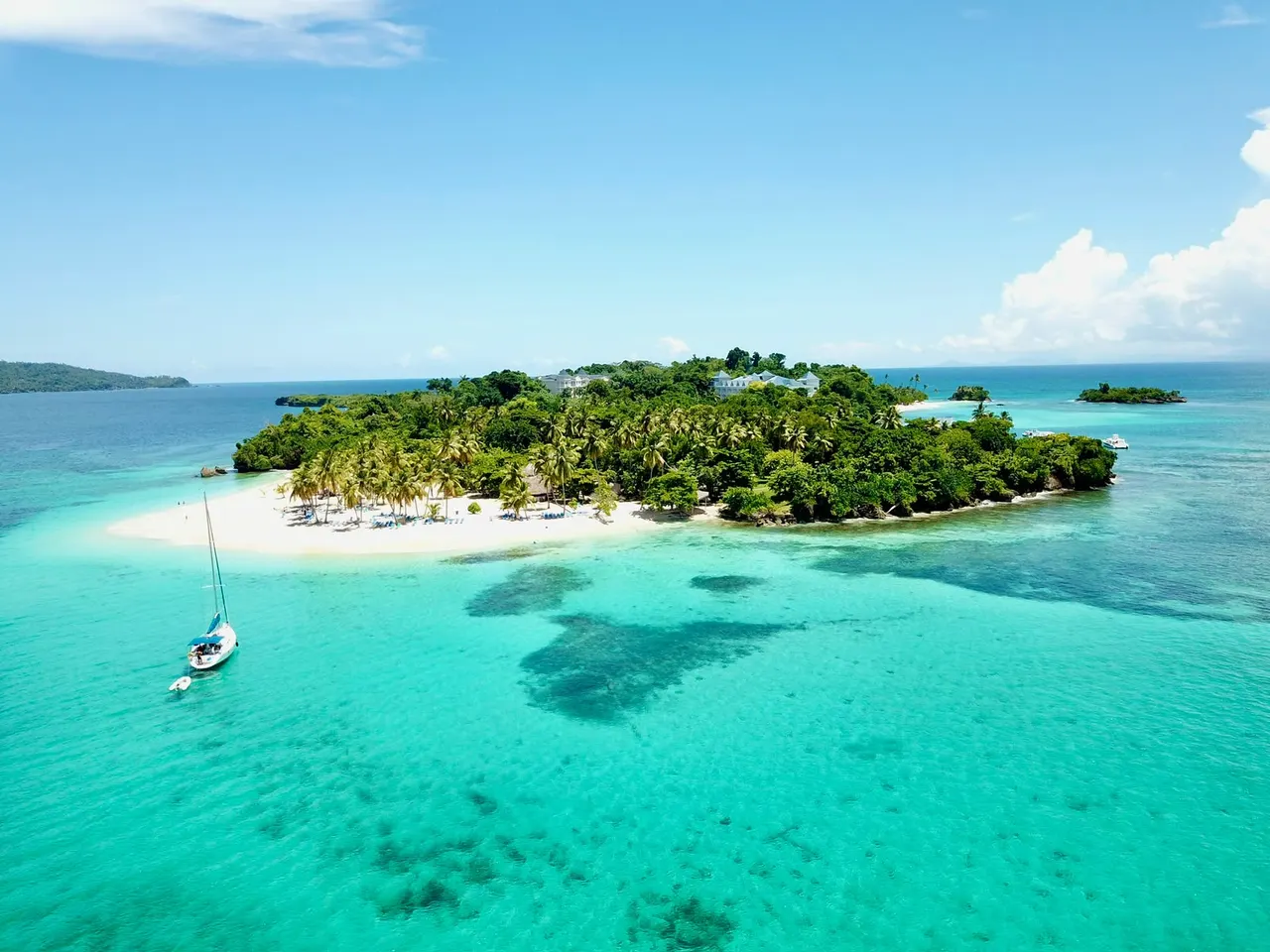 Aerial view of Cayo Levantado with a sailboat anchored off the beach