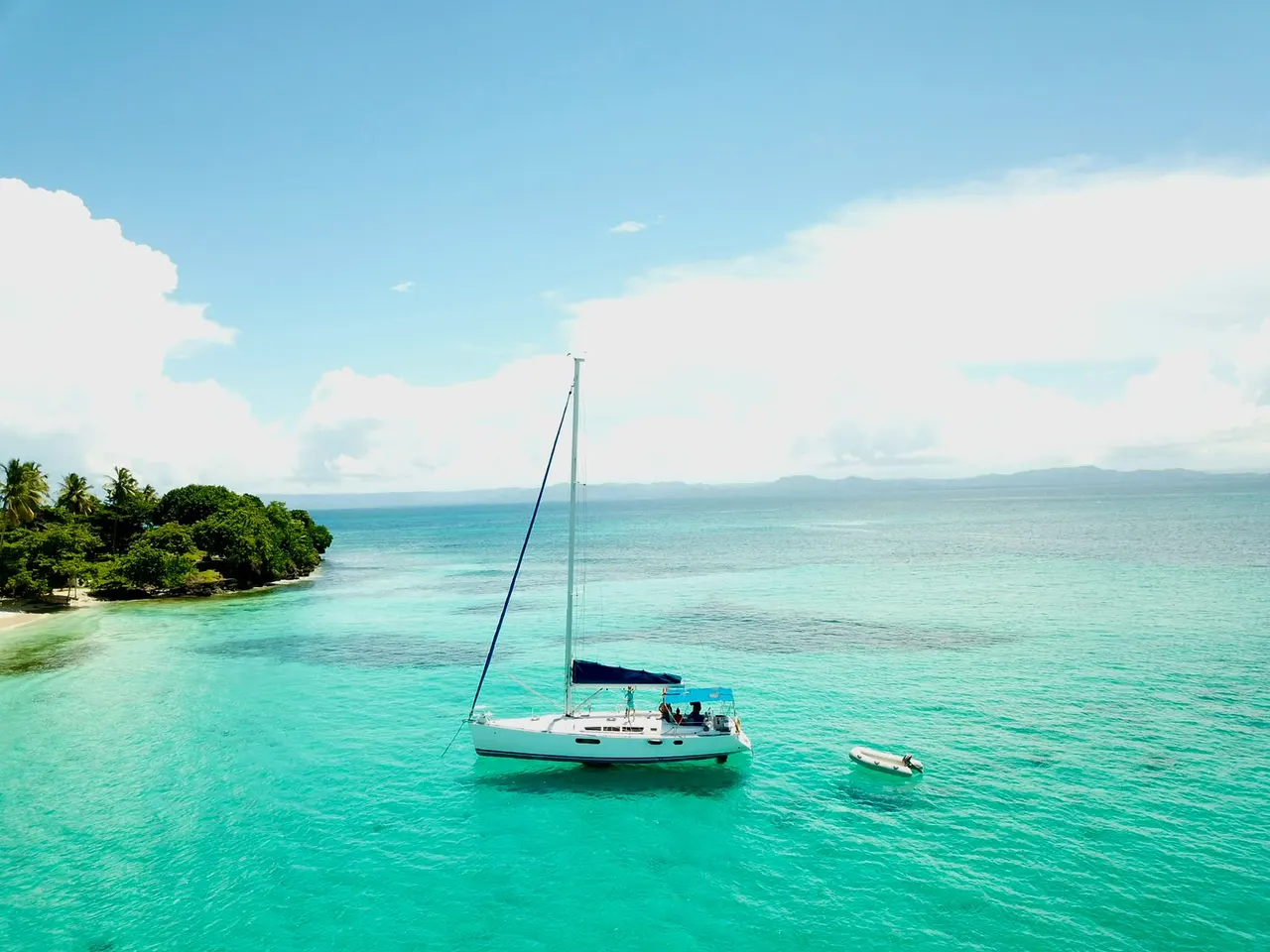 Sailboat anchored in turquoise water near Cayo Levantado