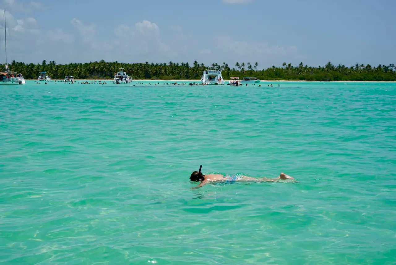 Guest snorkeling in shallow turquoise water