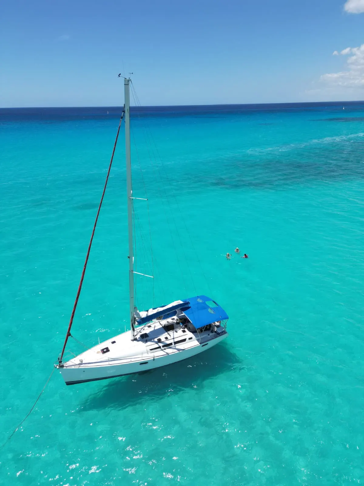 Sailboat anchored in clear turquoise water off La Romana