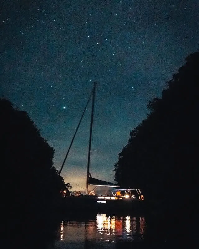 Sailboat at night under a starry sky in Los Haitises